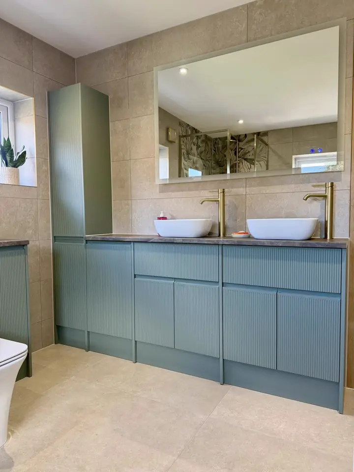 A finished bathroom by CMS Plumbing & Bathrooms — twin basins on a green vanity unit